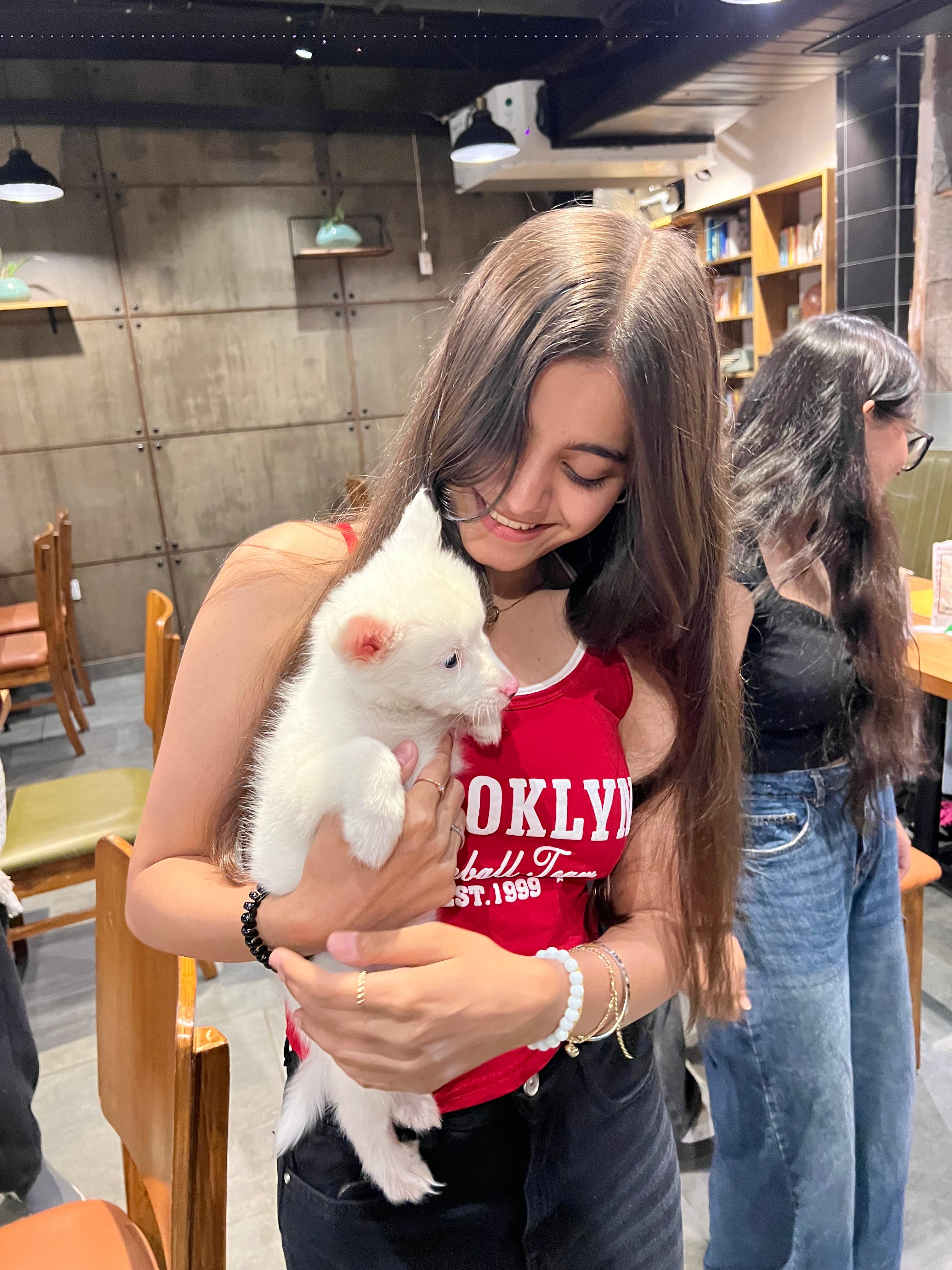 A customer holding a puppy at House of Espresso